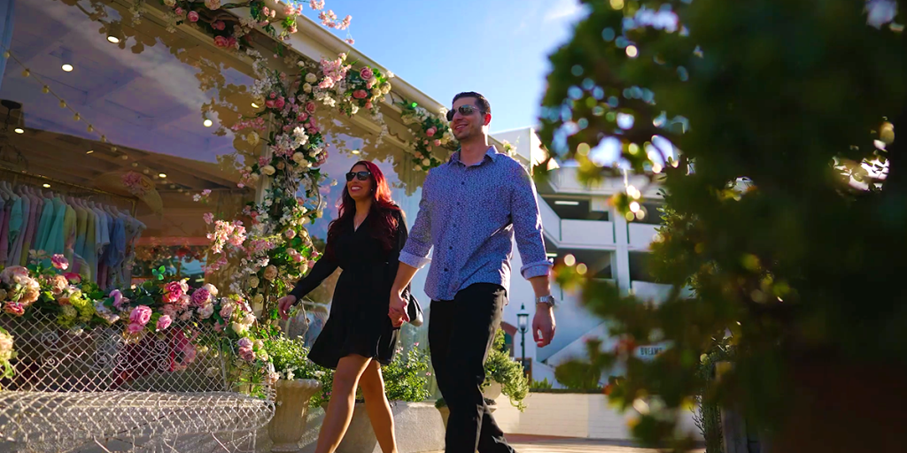 Couple walking in Lido Marina Village near Vision Electric Boat